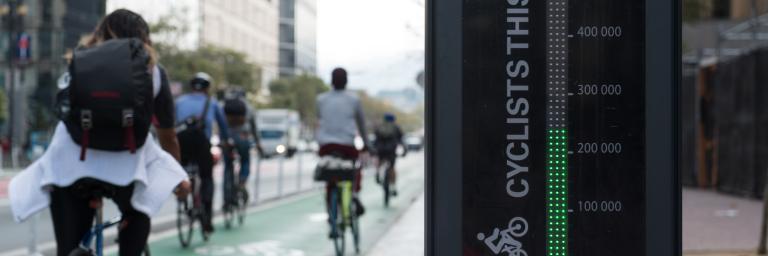 People biking past Market St bike totem